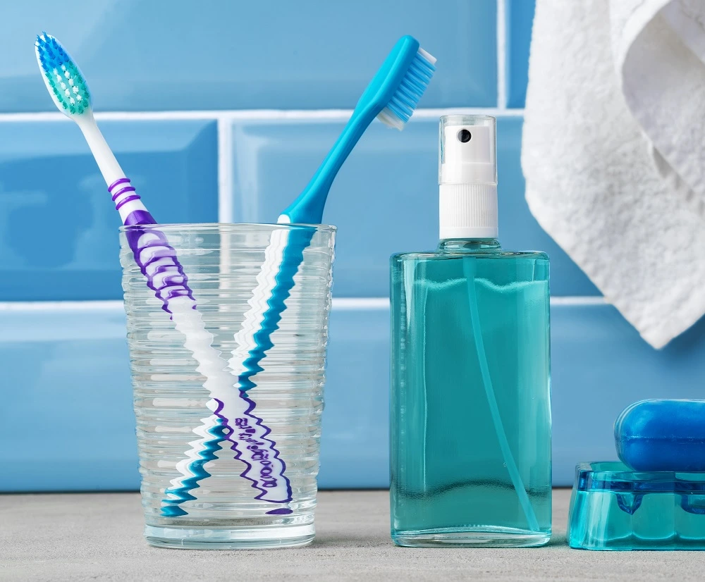 the-toothbrushes-in-a-glass-in-blue-bathroom