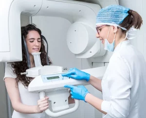 dentist-adjusting-setting-on-x-ray-machine