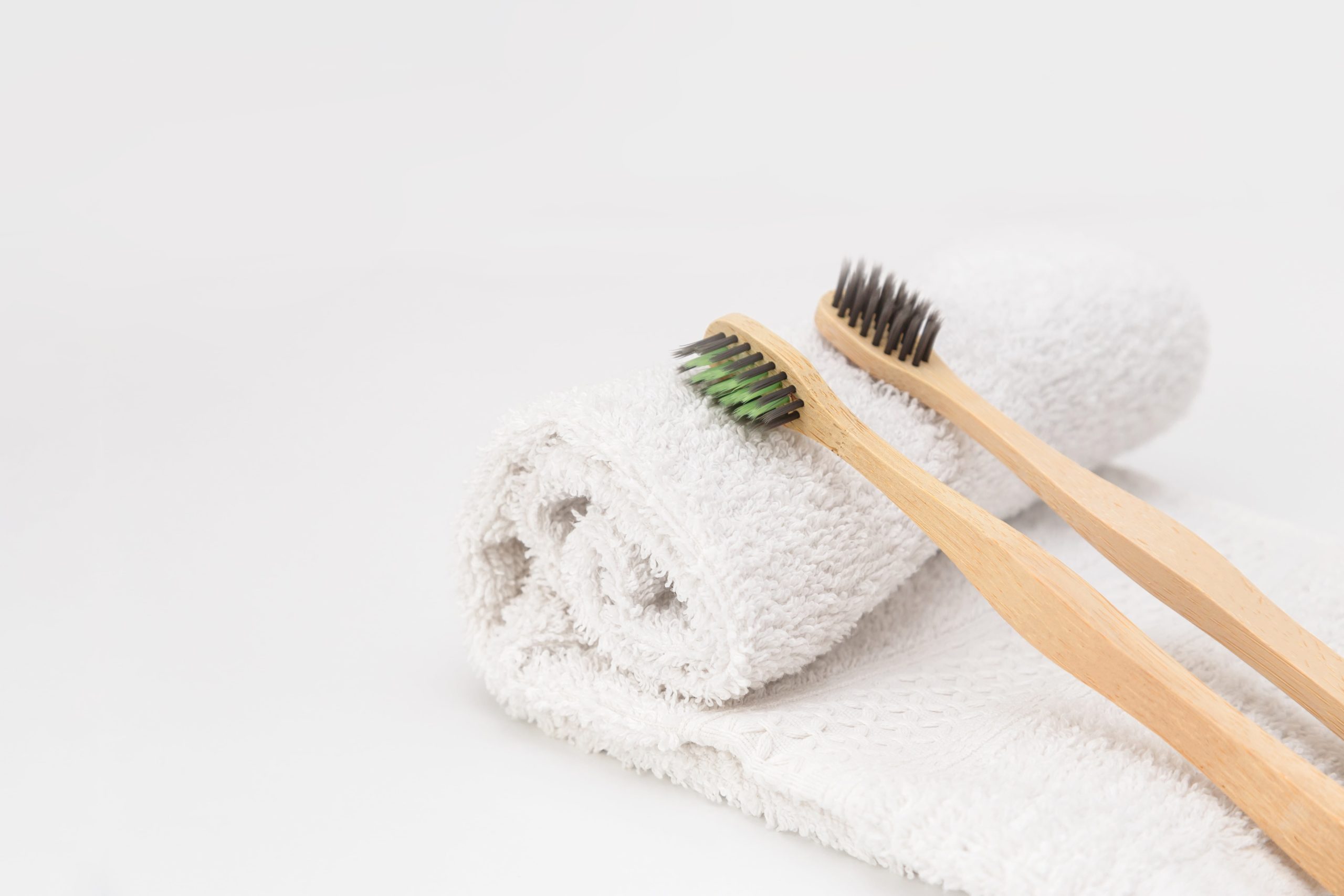 wooden-toothbrushes-on-white-towel