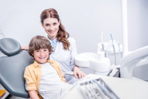 portrait of professional dentist and little boy in dentist office