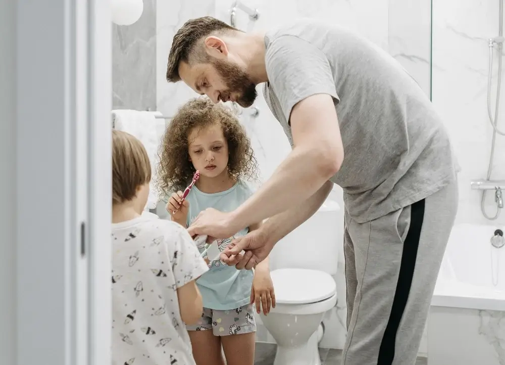 father-teaching-his-children-to-brush