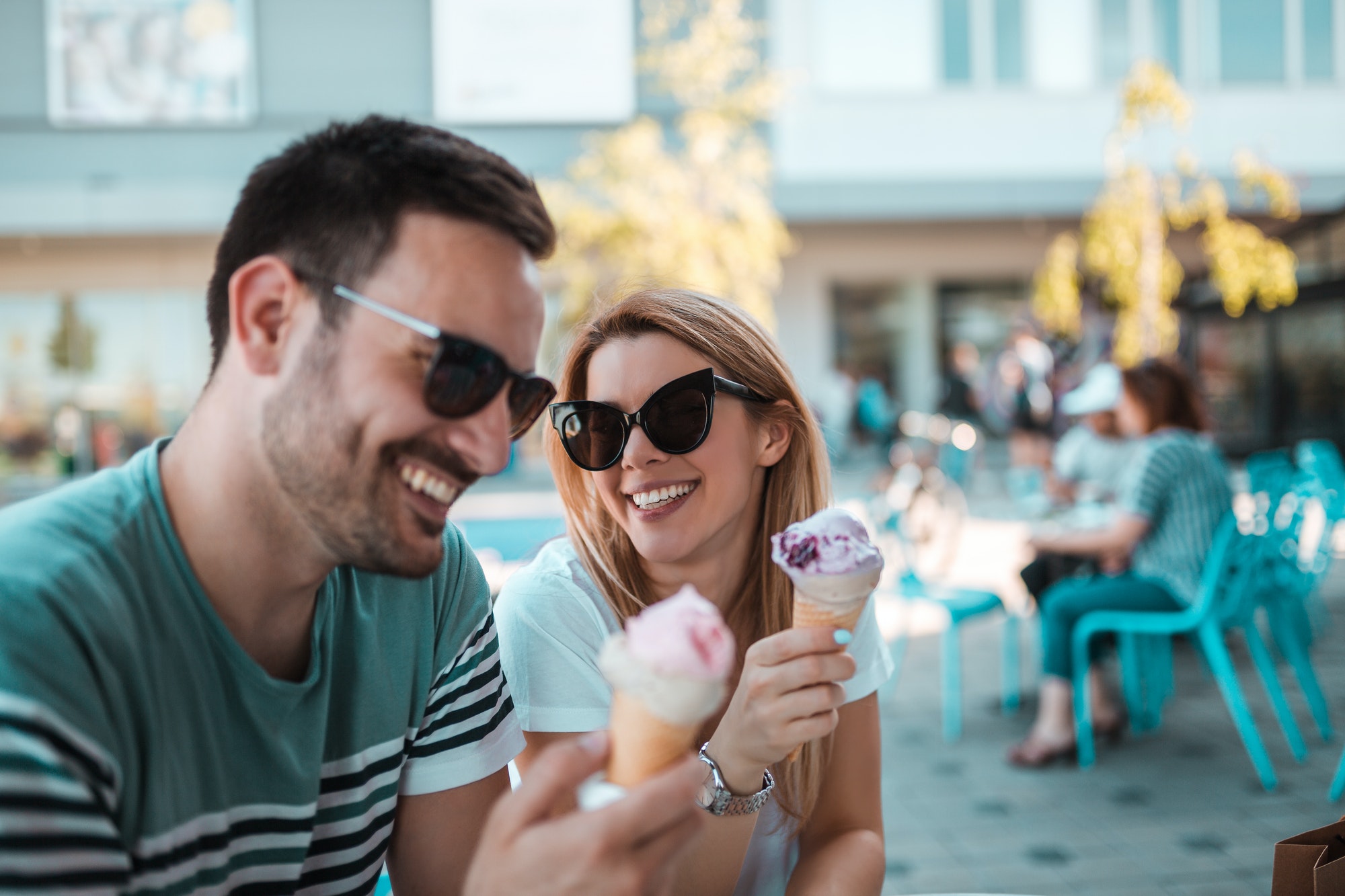a beautiful young couple with sunglasses are sitting outdoors and having ice creams in cornet - Channel Islands Family Dental Office | Dentist In Ventura County