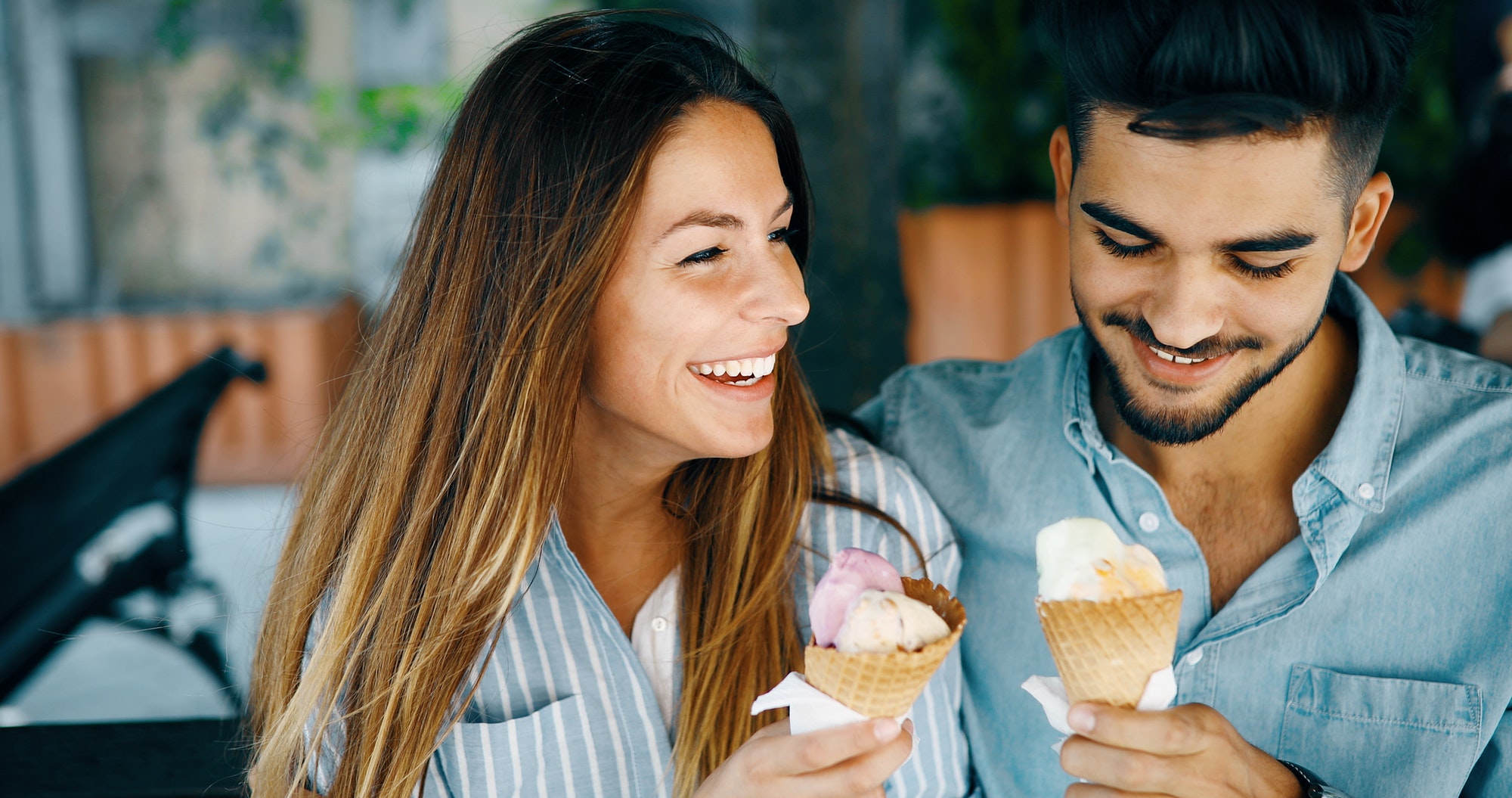 Happy couple having date and eating ice cream