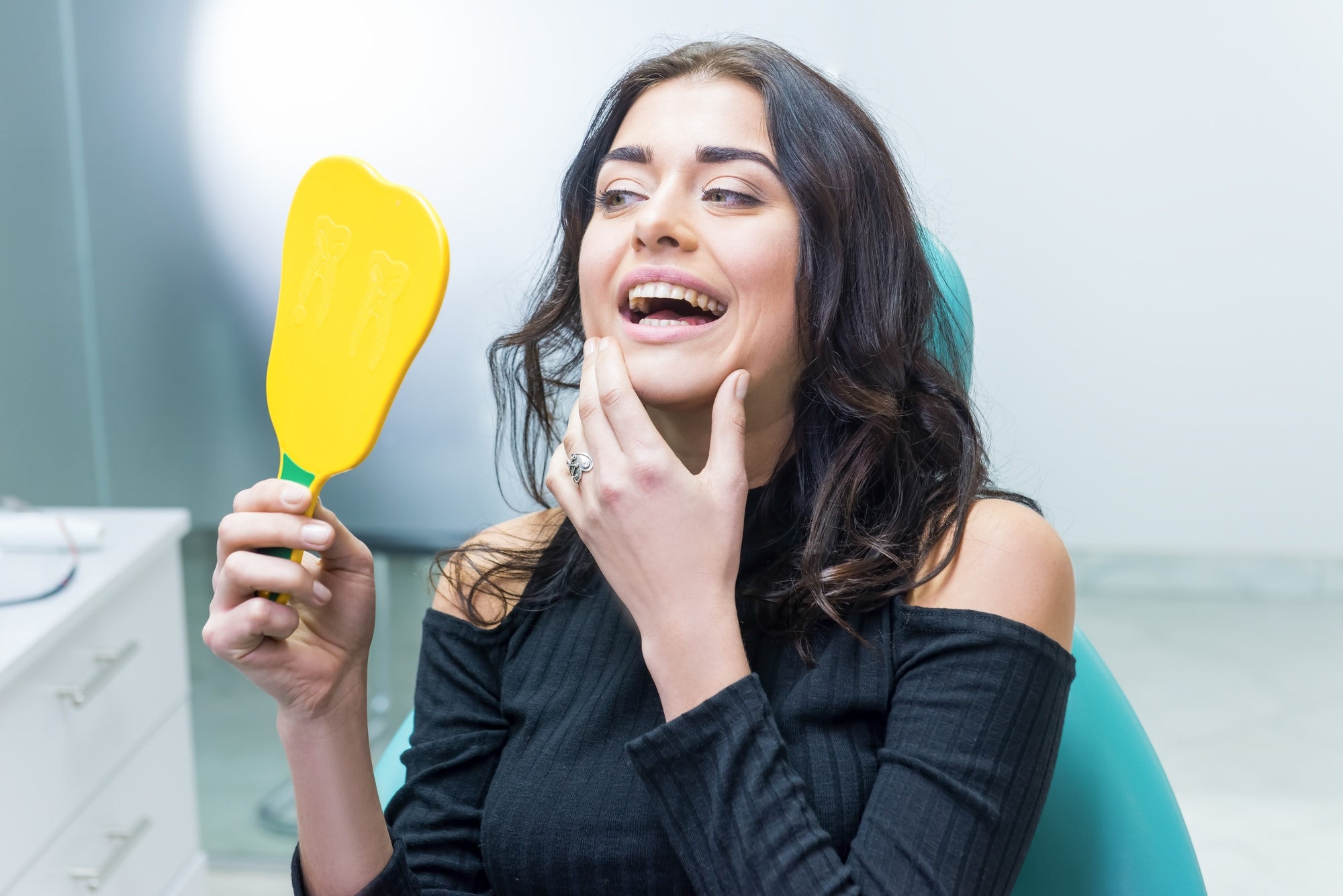 lady looking at her teeth - Channel Islands Family Dental Office | Dentist In Ventura County