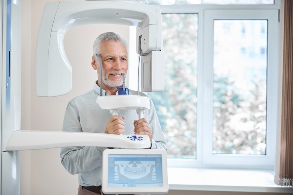elderly patient getting a panoramic dental x ray - Channel Islands Family Dental Office | Dentist In Ventura County