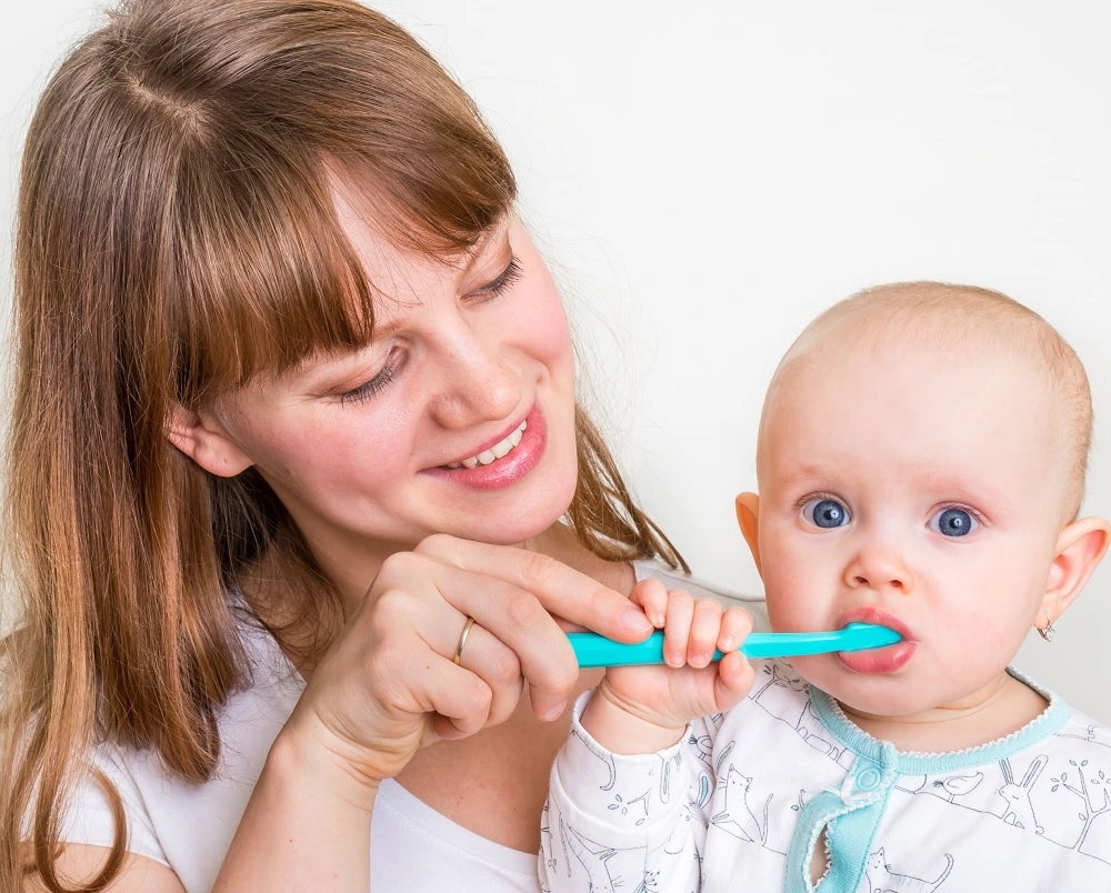 mother-brushing-her-babys-teeth