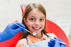 Girl visiting dentist, examining teeth health, dental care. Stomatology, toothache, caries filling