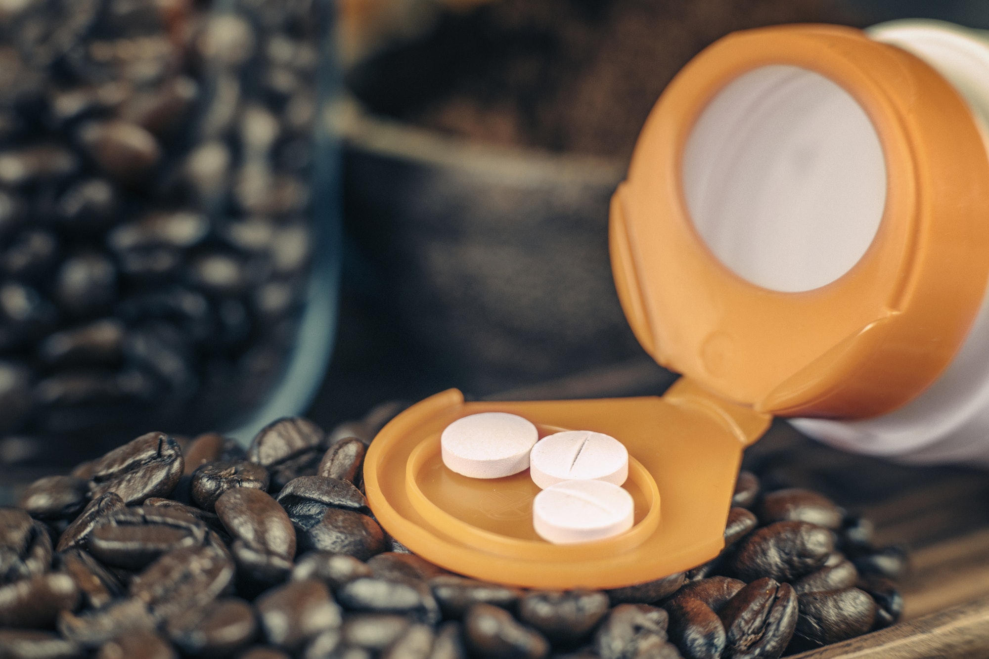 Caffeine Supplementation Bottle with Pills and Coffee Beans