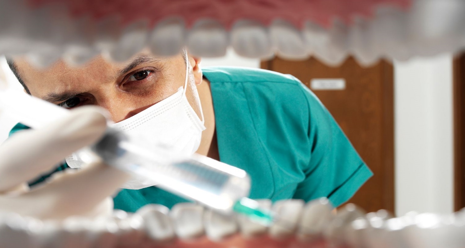 dentist having a treatment to a patient 