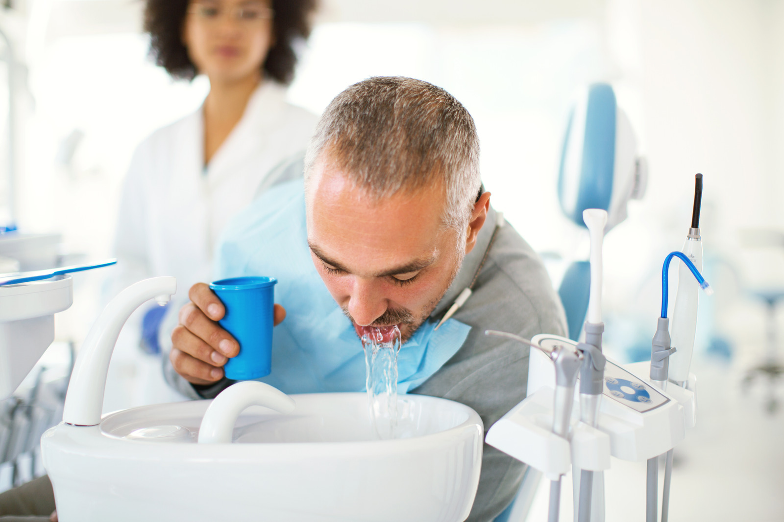 Mouth rinse during a dental procedure.