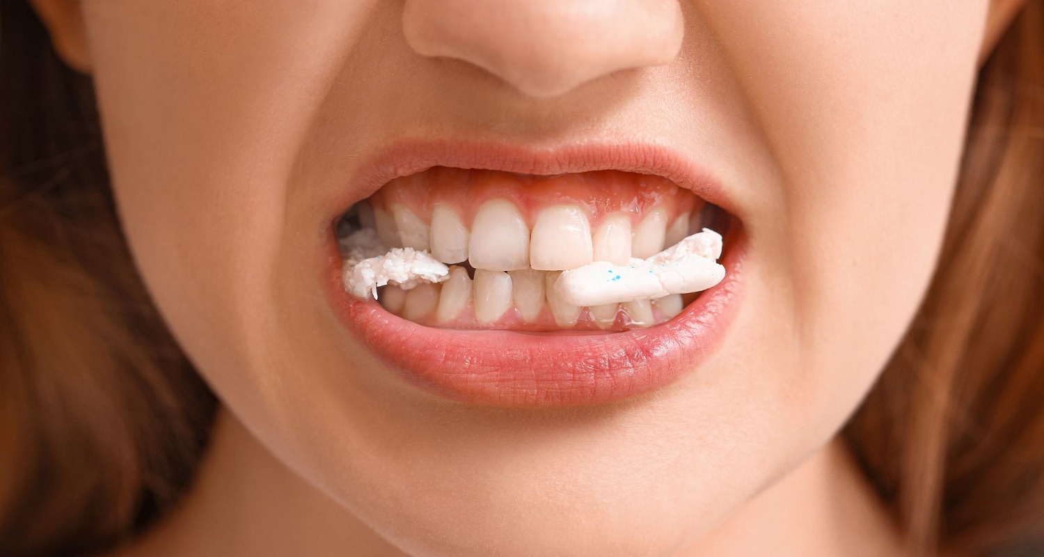 a women biting a plastic