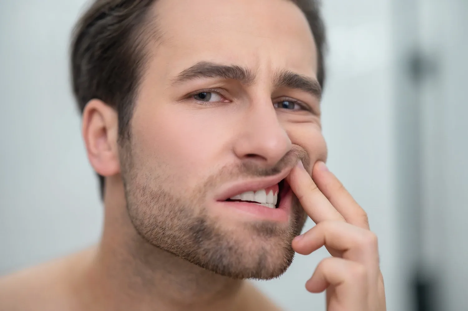 man checking his teeth