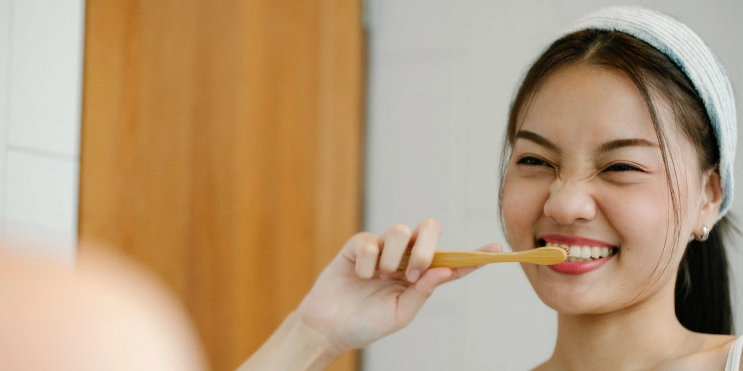 woman is brushing her teeth