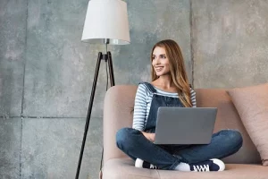 beautiful-woman-smiling-and-sitting-on-sofa