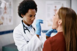 black-female-doctor-examining-throat-of-female-patient