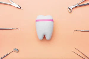 dentist-tools-around-the-tooth-orange-background-2022-11-15-05-25-18-utc-min