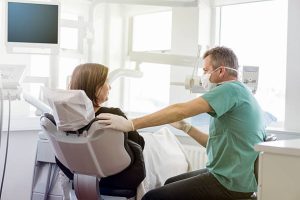 Dentist is explaining woman
