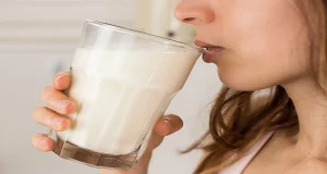 woman drinking a glass of milk