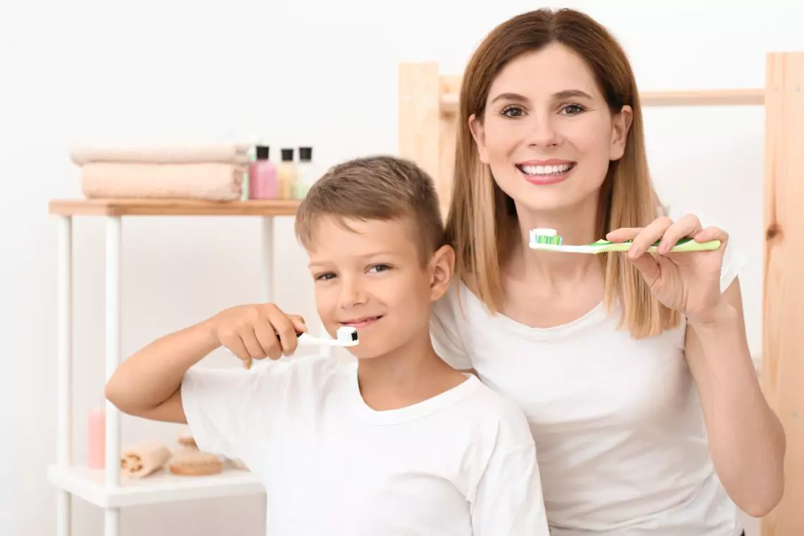 Mother and son brushing their teeth