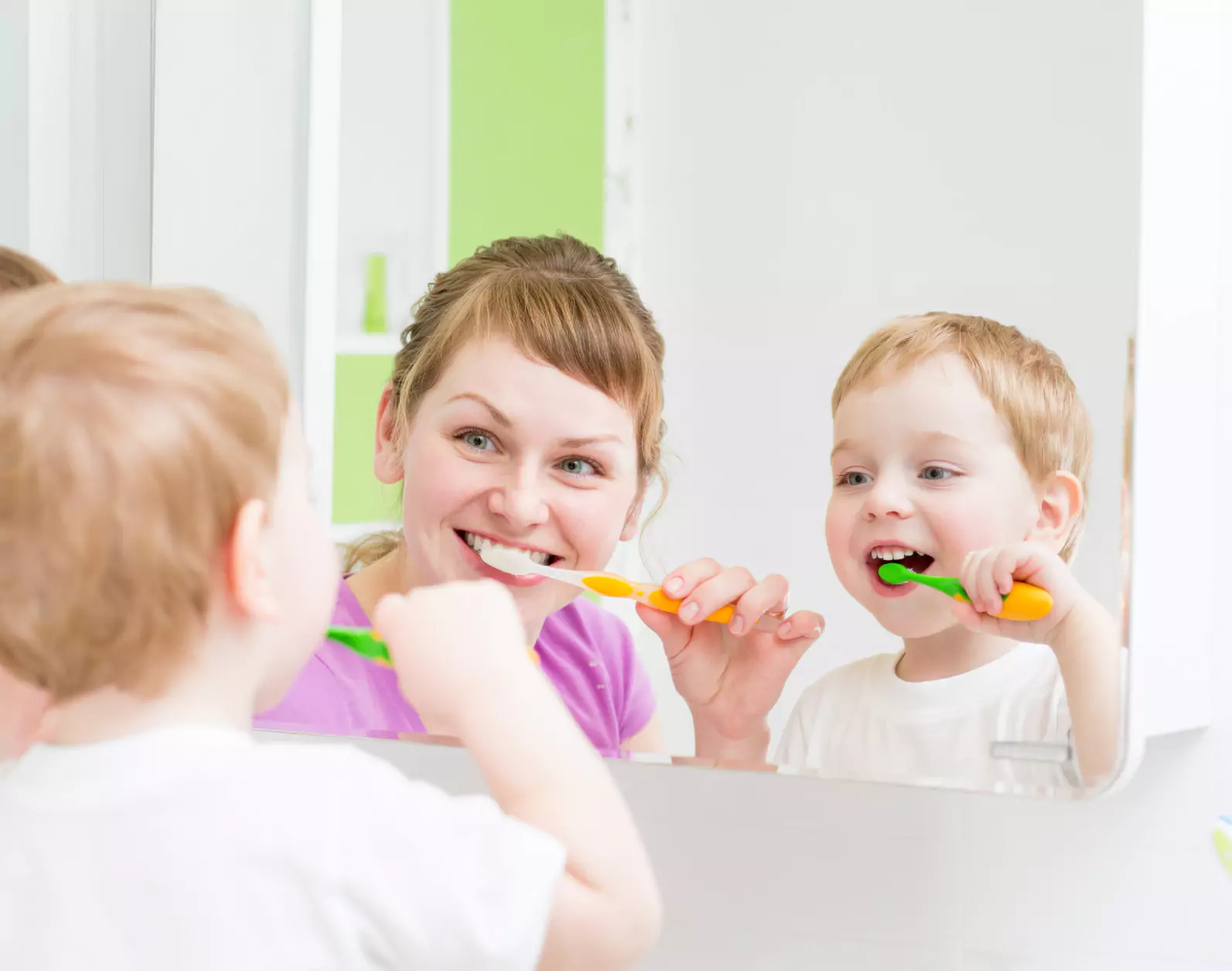 Mother and son brushing their teeth
