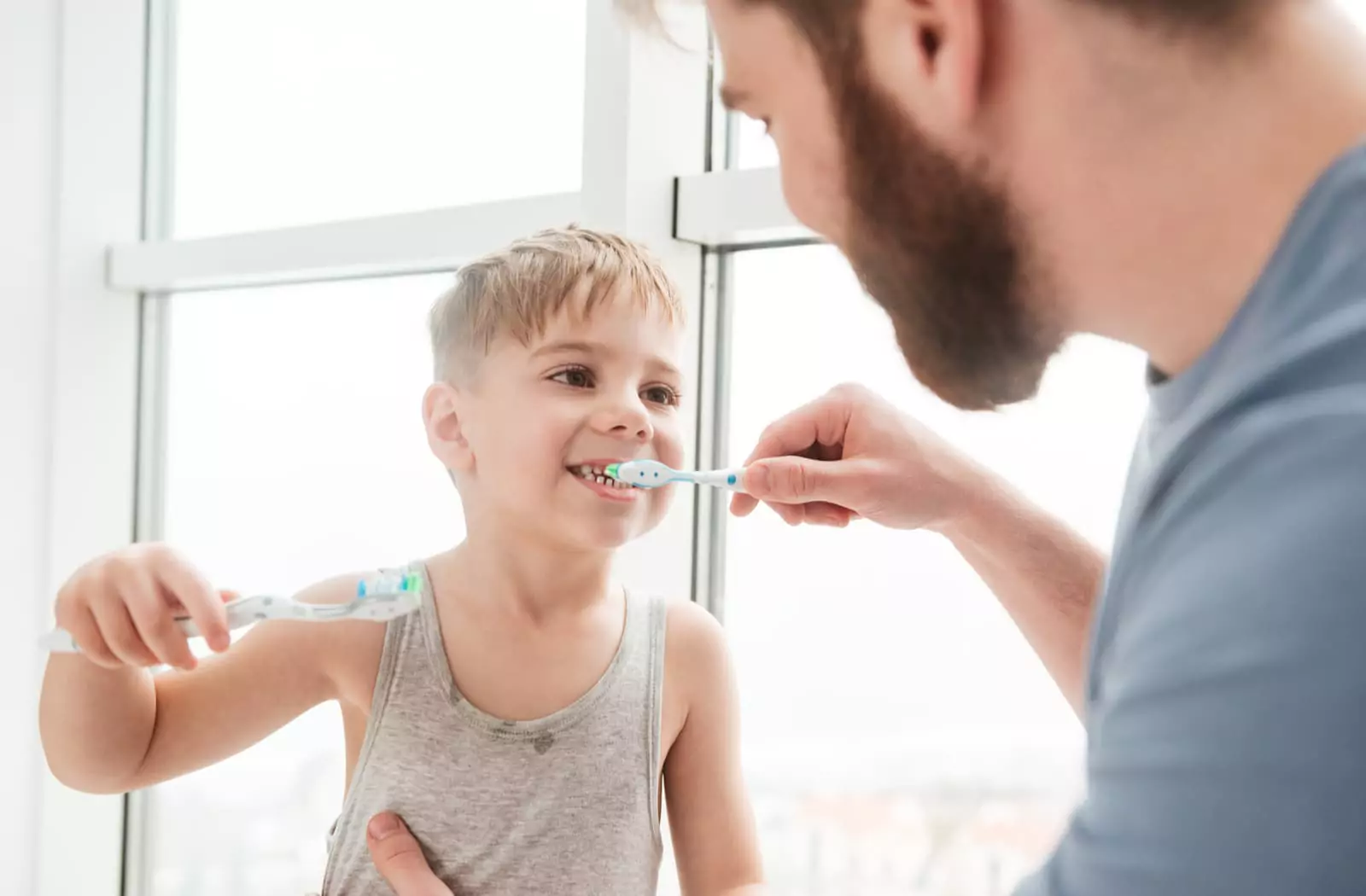 Father and son brushing