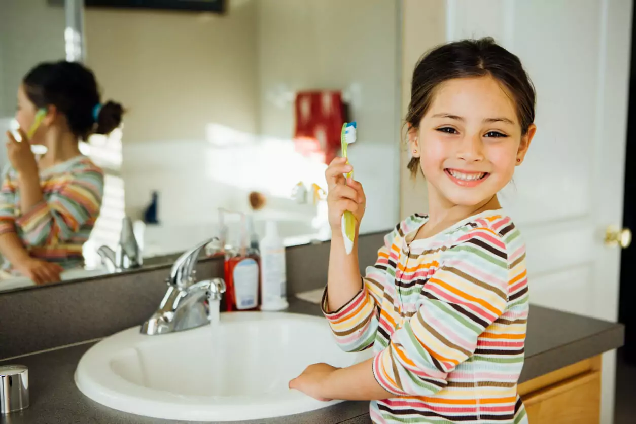 girl brushing her teeth