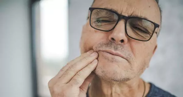 How does arthritis make dental care more challenging?
