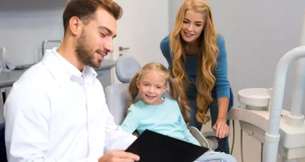 When should parents take a child to the dentist?